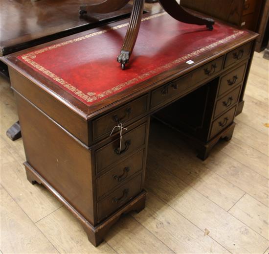 A Georgian style mahogany pedestal desk inset red skiver W.122cm